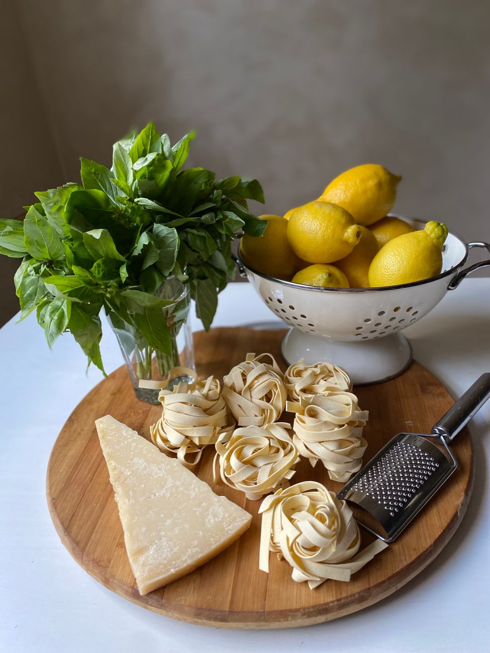 Rustic Italian pasta table with lemons and coastal terrace view
